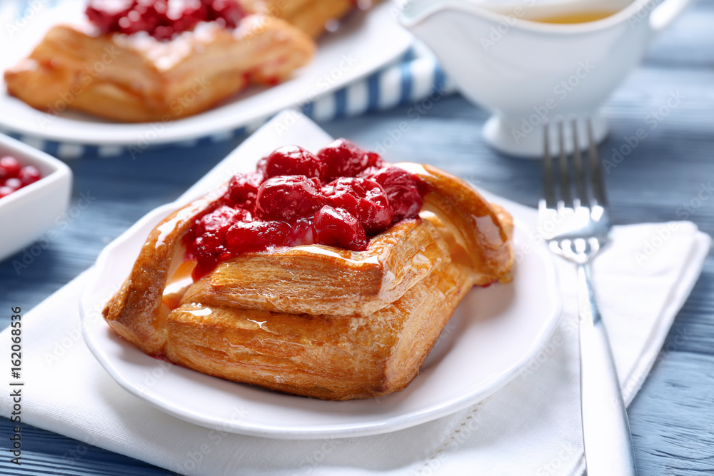 Delicious pastries with berries on served table Delicious pastries with berries on served table