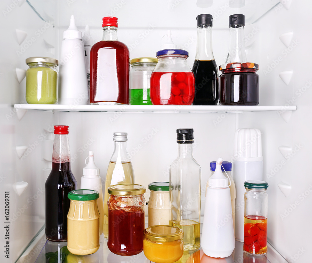 Many different sauces in fridge Many different sauces in fridge