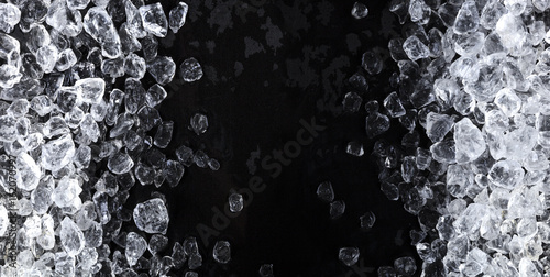 Fotografía Pieces of crushed ice cubes on black background