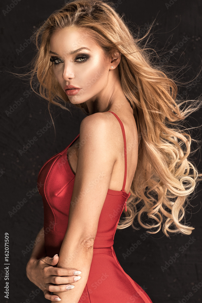 Naklejka premium Beautiful blonde woman in red dress.