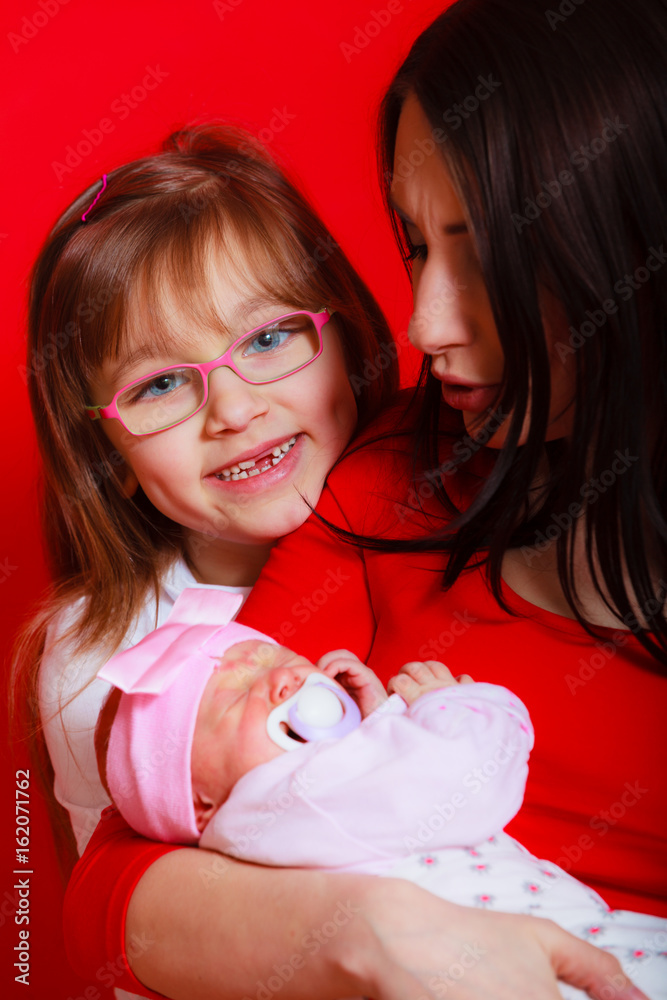 Mother with toddler daughter and newborn baby Mother with toddler daughter and newborn baby