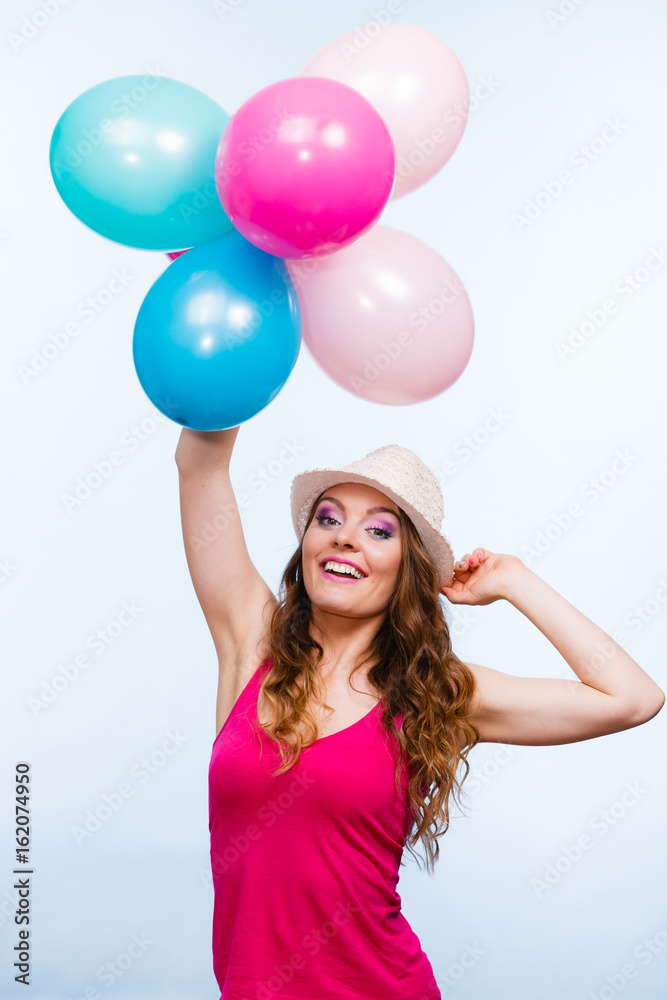 Woman playing with many colorful balloons Woman playing with many colorful balloons