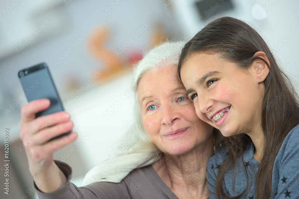 two generation women making a funny selfie together two generation women making a funny selfie together