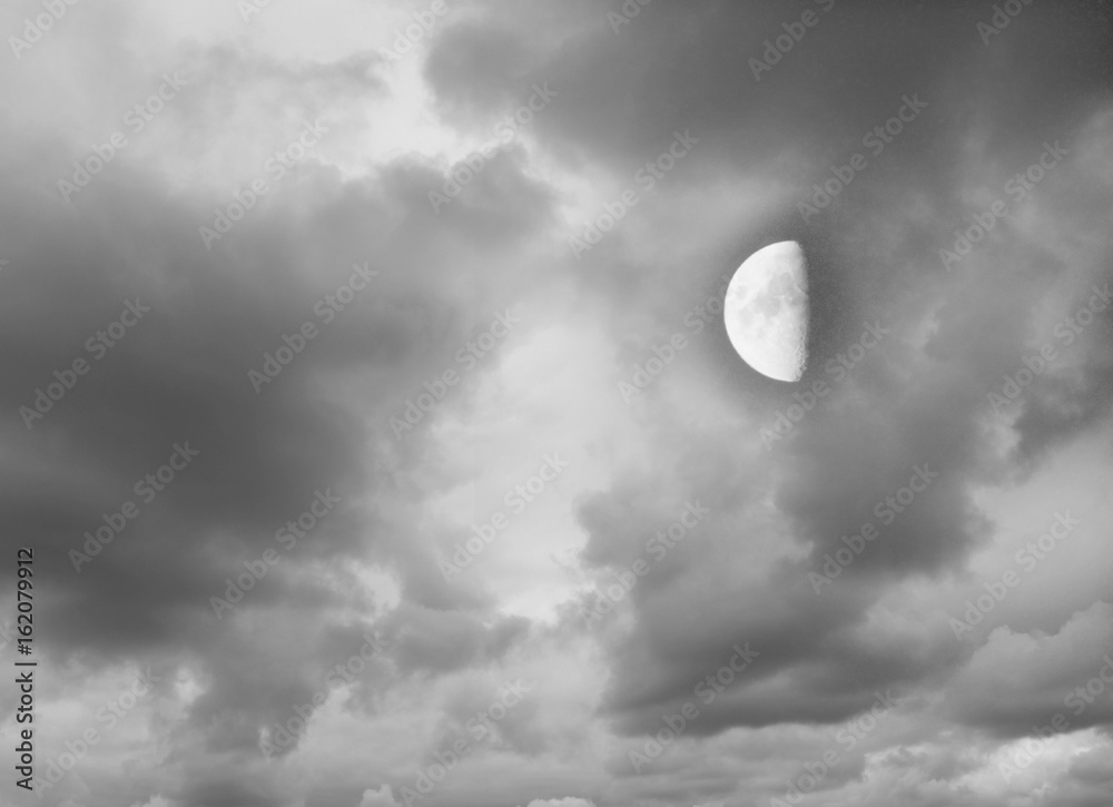 Moon in the dark cloudy sky