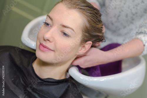 hairdresser salon woman during hair wash