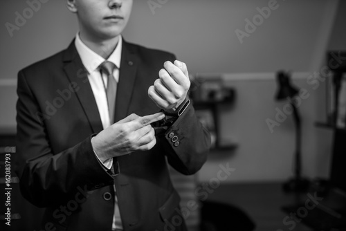 groom Dresses the watch on his wedding day