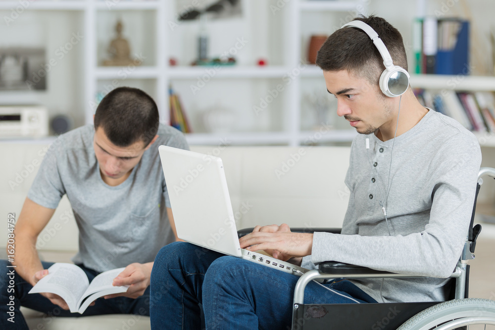 two male students going over their homework two male students going over their homework