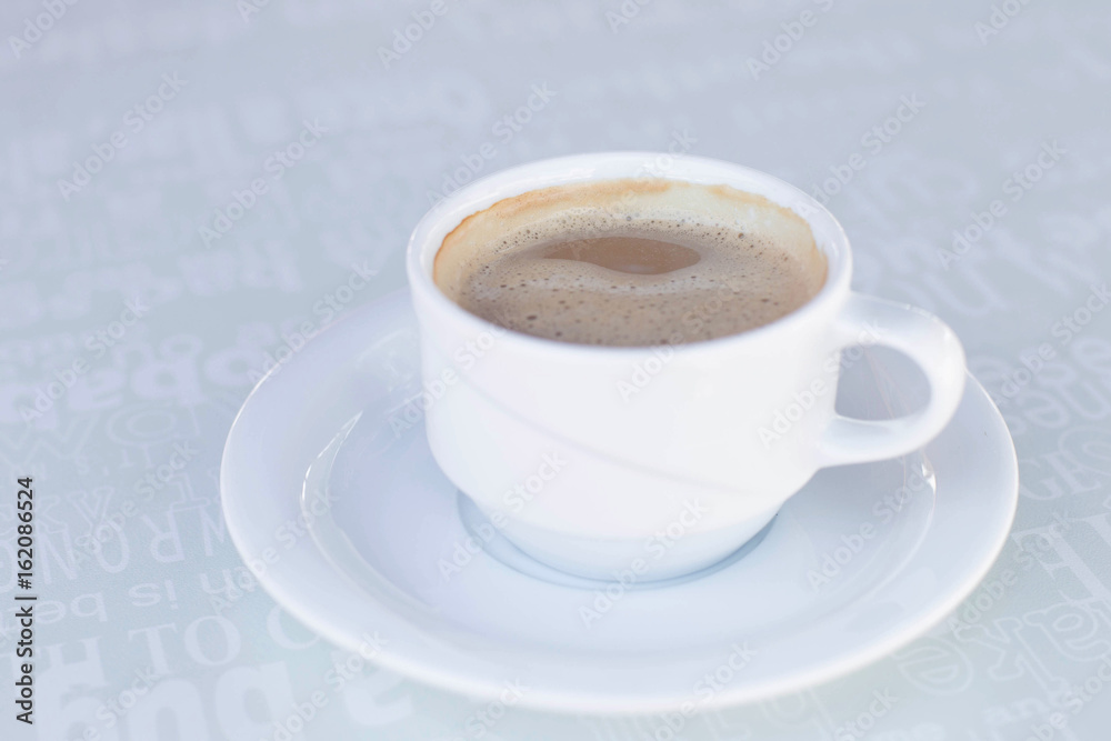 Fototapeta premium One cup of coffee on the plate on the table