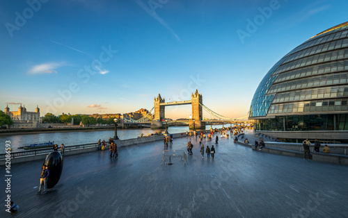 Panoramic view of Southwark Skyline and tower bridge with people at sunset. photo