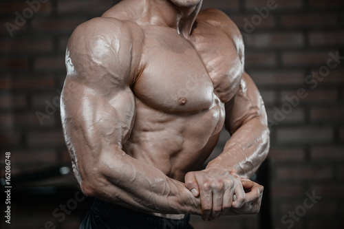 Strong bodybuilder man at the gym