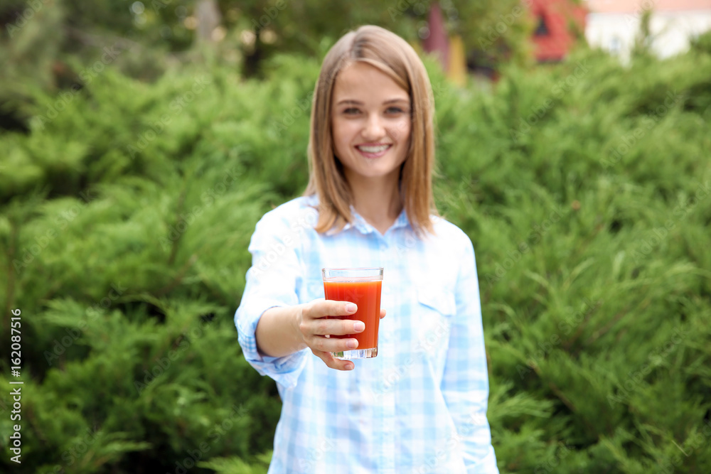 Young beautiful woman with fresh juice in park Young beautiful woman with fresh juice in park