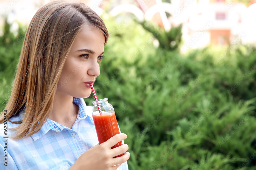 Young beautiful woman with fresh juice in park Young beautiful woman with fresh juice in park