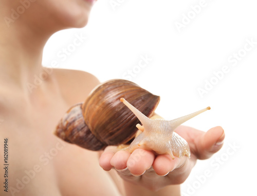 Female hand with giant Achatina snail on white background, closeup