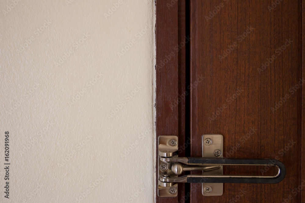 Security lock equipment on the wooden door close up. Security lock equipment on the wooden door close up.