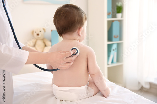 Doctor examining little bab...