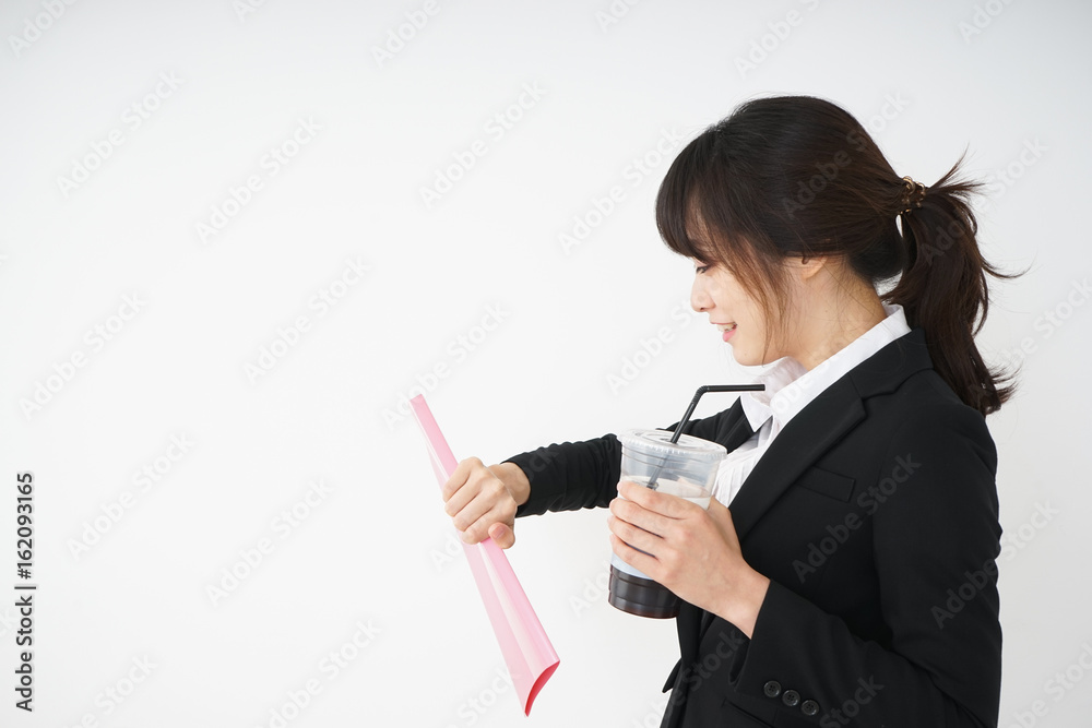Young businesswoman drinking ice coffee at office Young businesswoman drinking ice coffee at office