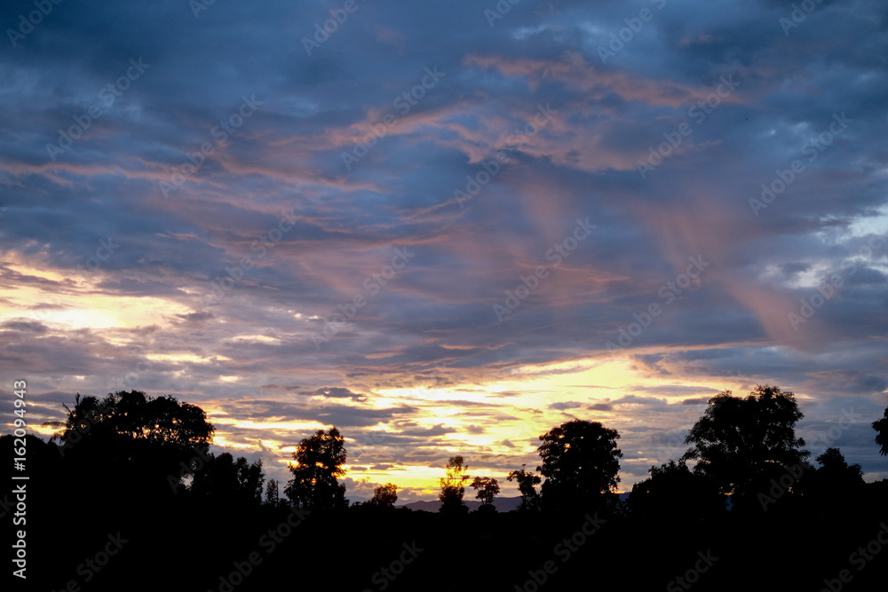 Silhouette of agricultural plots in Thailand, Along with the sky was covered with the main stem from the rain at dusk. Beautiful landscape. Silhouette of agricultural plots in Thailand, Along with the sky was covered with the main stem from the rain at dusk. Beautiful landscape.