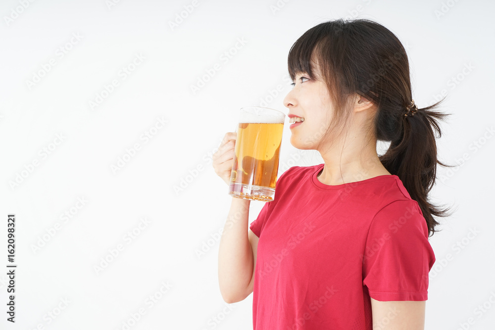 Young woman cracking a beer after an exercise Young woman cracking a beer after an exercise