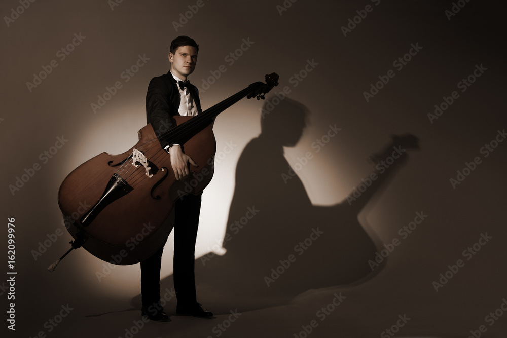 Fototapeta premium Classical musician studio portrait with double bass