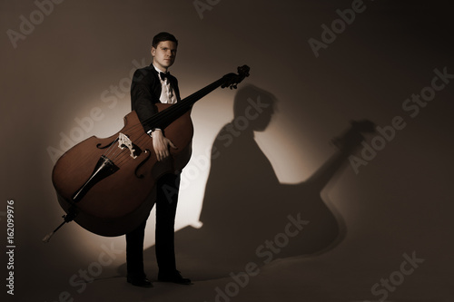 Classical musician studio portrait with double bass