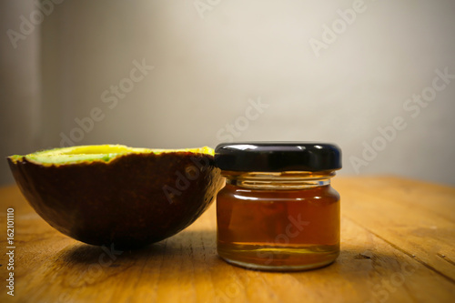 Avocado and honey on wooden floor, healthy concept, organic food concept