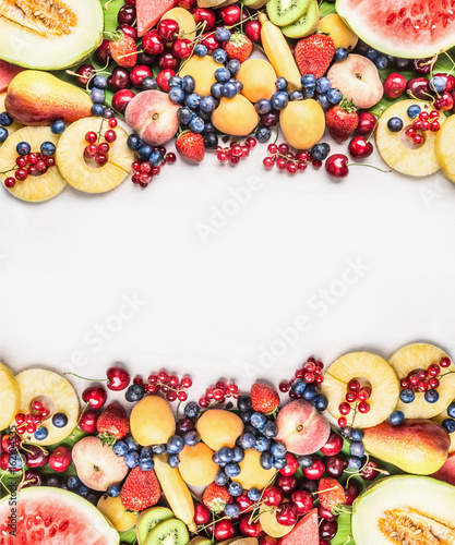 Fototapeta Naklejka Na Ścianę i Meble -  Healthy food background with various  fruits on white wooden background, top view, copy space, frame