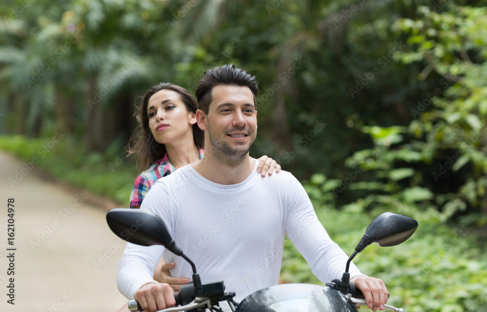 Happy smiling and screaming male tourist in helmet and sunglasses riding motorbike  scooter during his tropical vacation under palm trees Stock Photo - Alamy