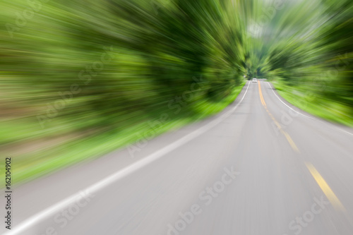 Road in motion speed on the forest road blurred background concept Tunnel effect or Visual tunnel phenomenon