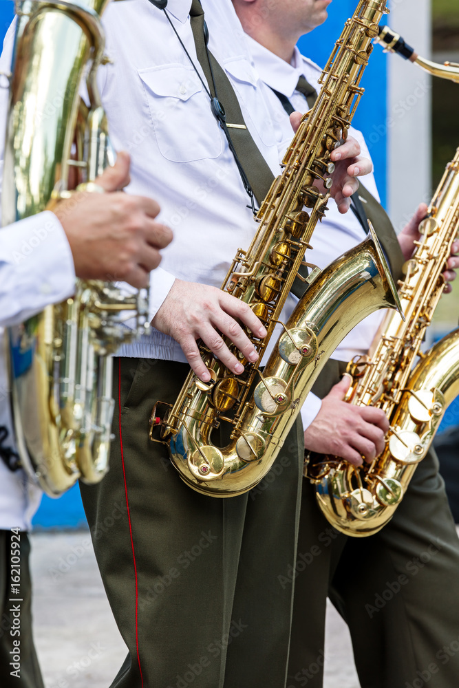 Fototapeta premium military orchestra musicians playing saxophones during brass bands fest