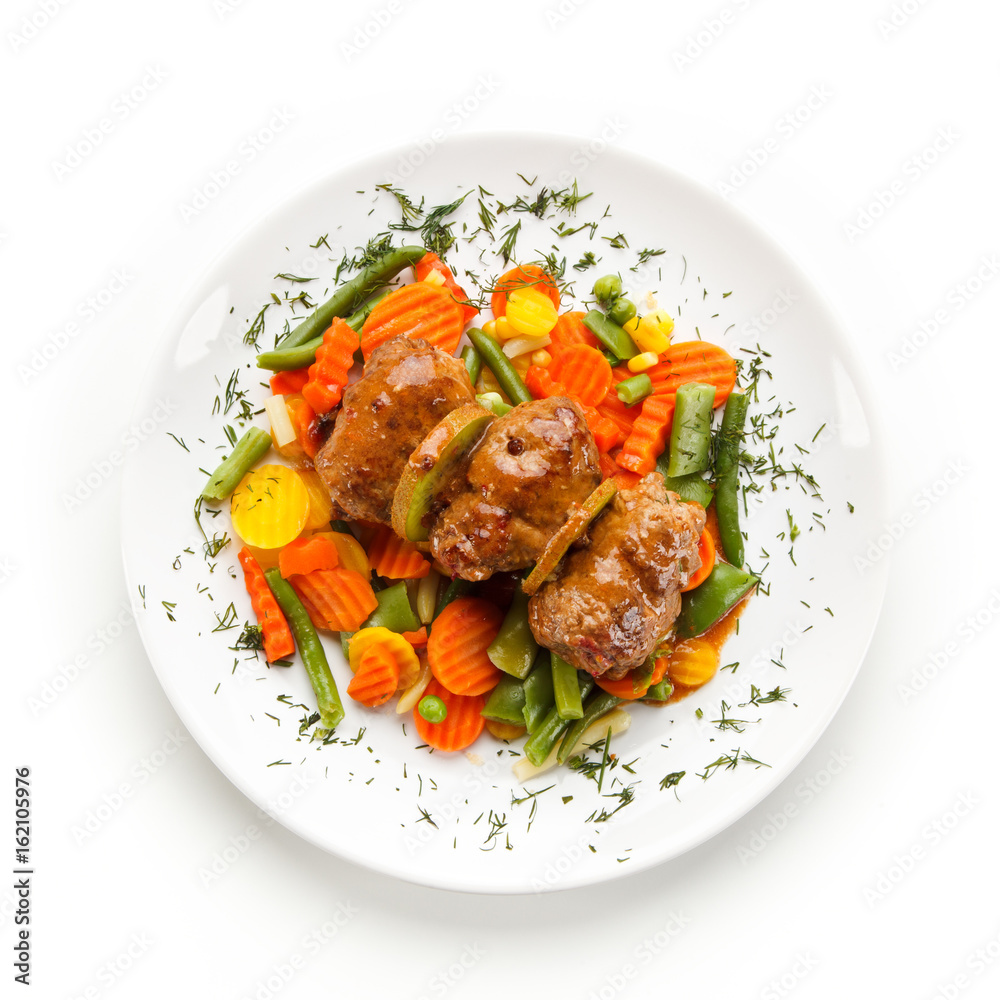 Fototapeta premium Wrapped pork chops and vegetables on white background 