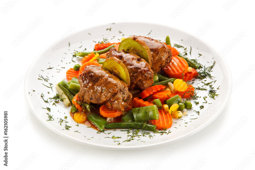 Wrapped pork chops and vegetables on white background Wrapped pork chops and vegetables on white background
