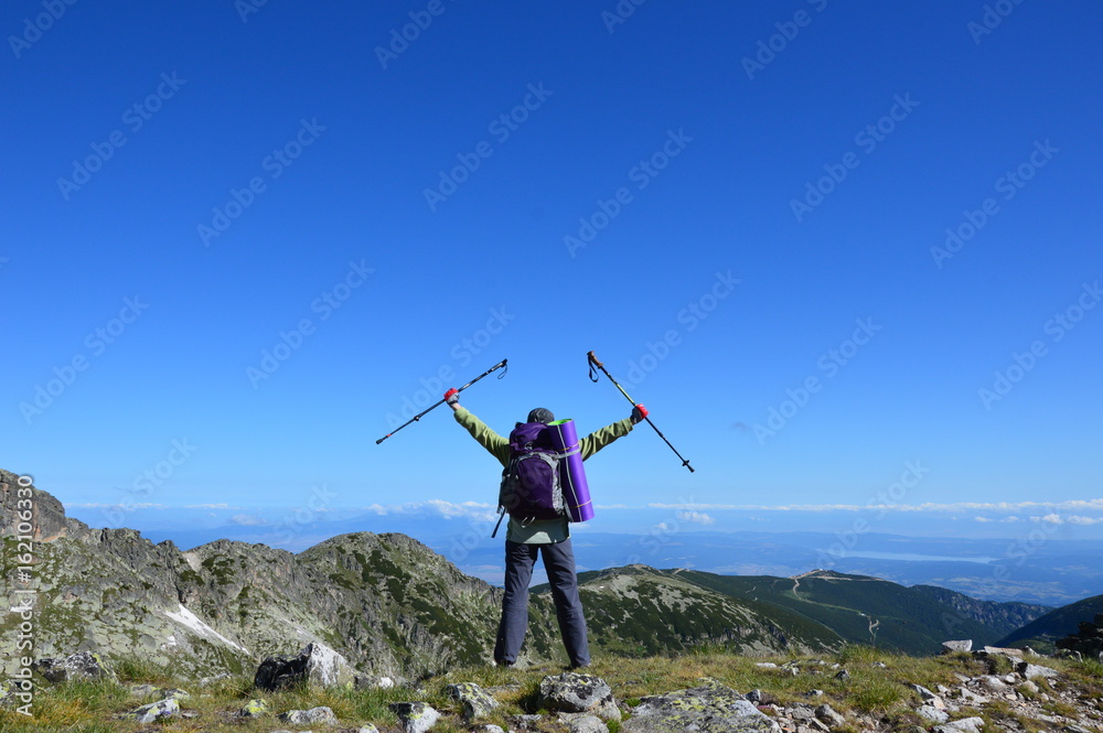 Person successful hiking at mountain peak