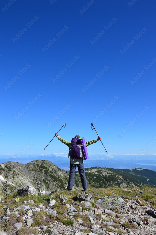 Person successful hiking at mountain peak