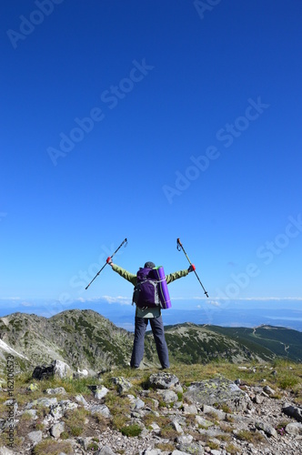 Obraz na płótnie Person successful hiking at mountain peak w salonie