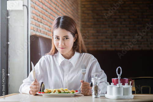 asian cute woman happy with her food  lunch spagetti in restaurant