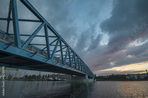 Steel bridge over the river in the industrial part of the city of Szczecin