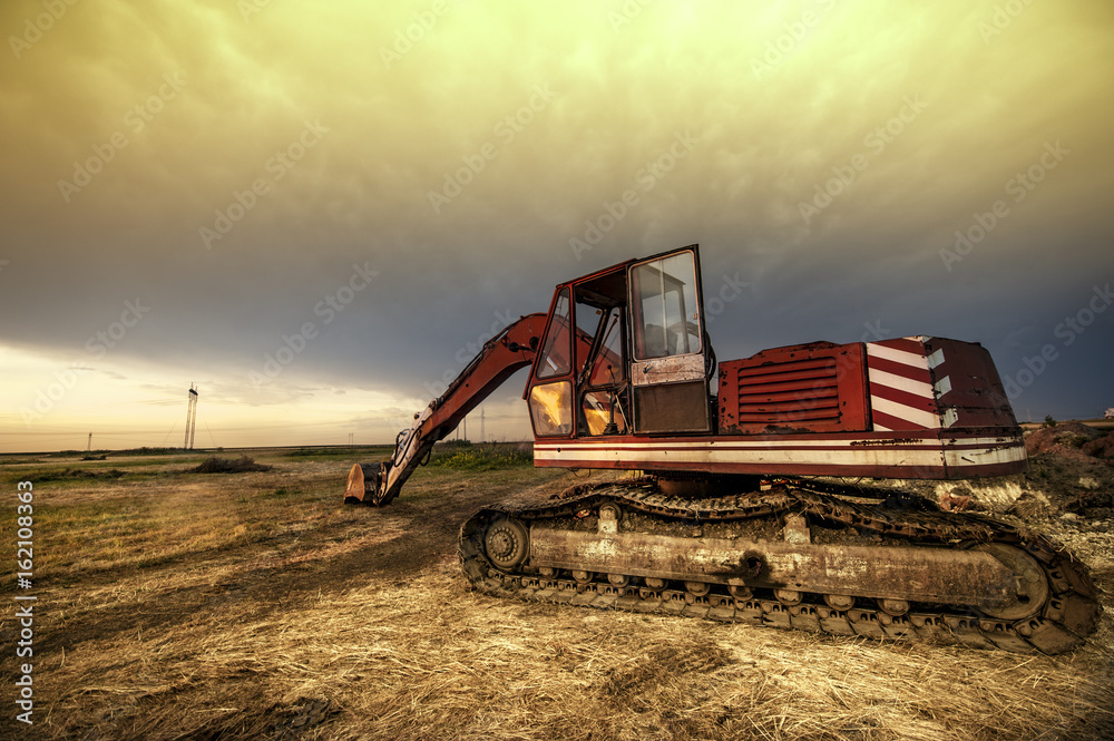 Fototapeta premium Dramatic landscape with bagger