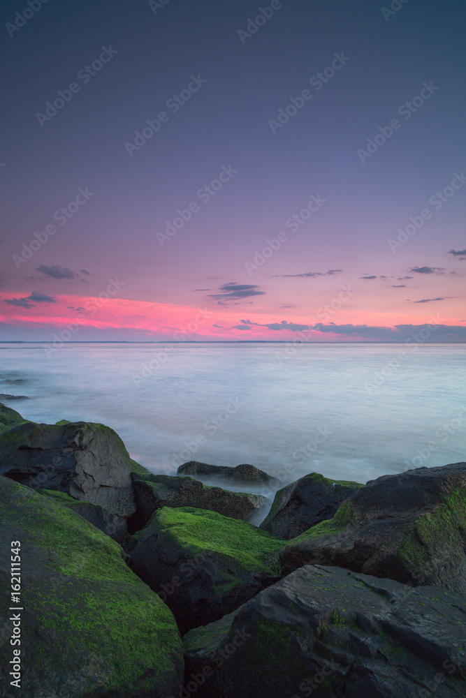 Sunset on a rock moss beach