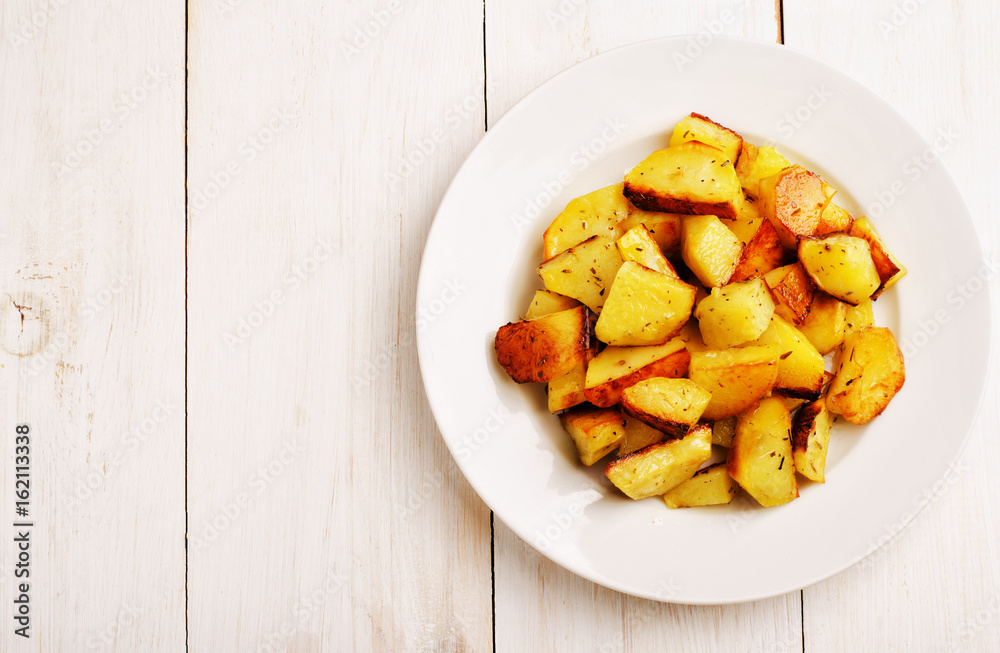 Baked potatoes in a white plate Baked potatoes in a white plate
