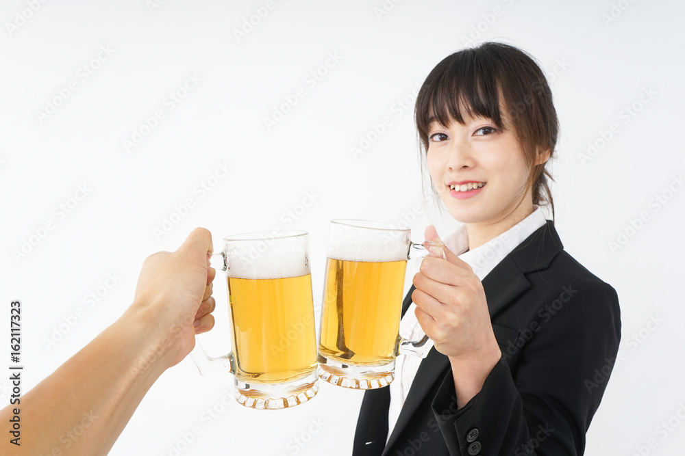 Businesswoman in suit cracking a beer Businesswoman in suit cracking a beer