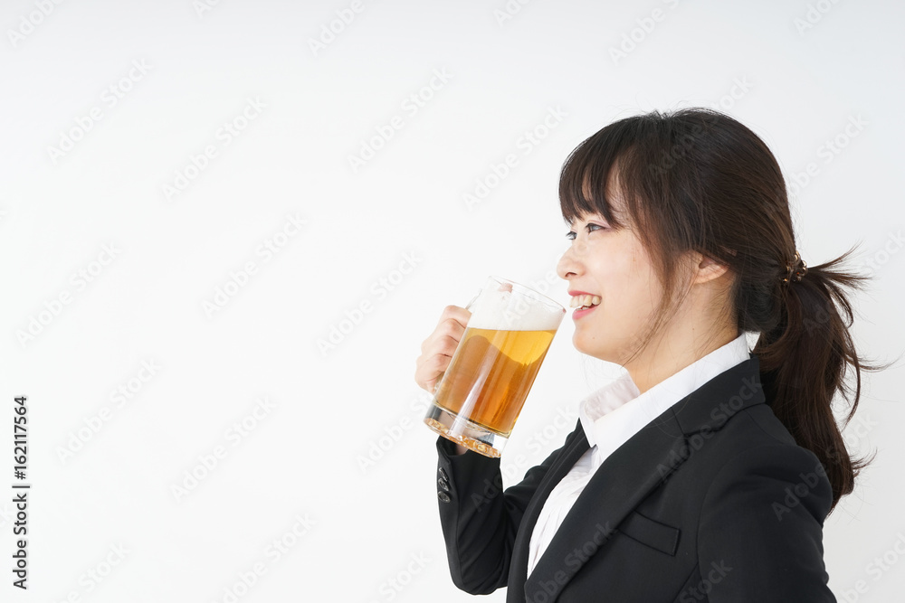 Businesswoman in suit cracking a beer Businesswoman in suit cracking a beer