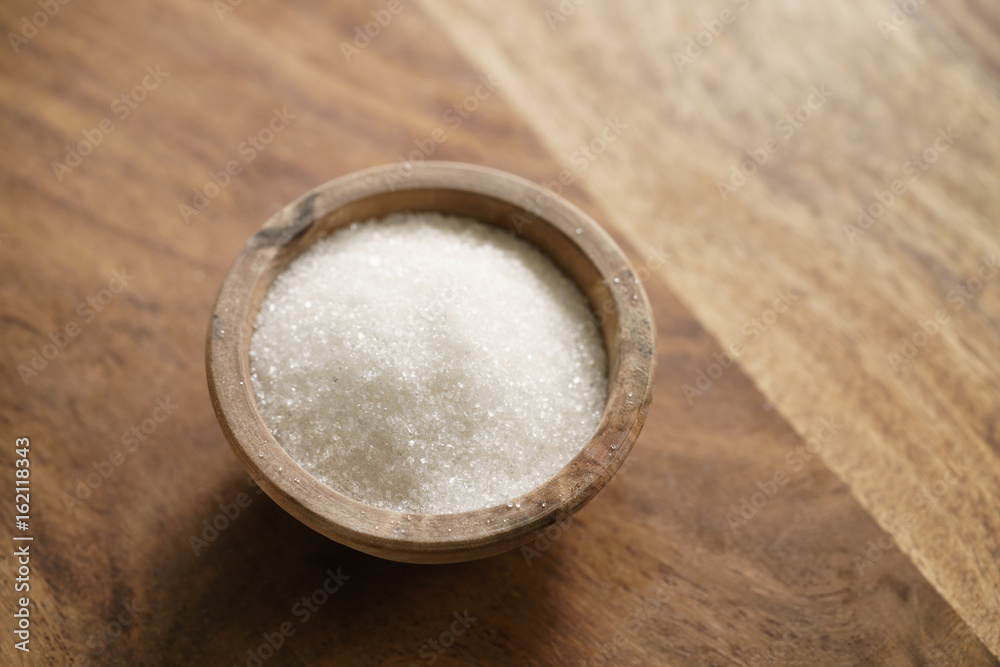 sugar in wood bowl on wooden table sugar in wood bowl on wooden table