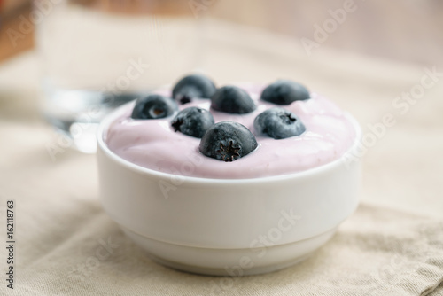 organic blueberry yogurt in bowl on table