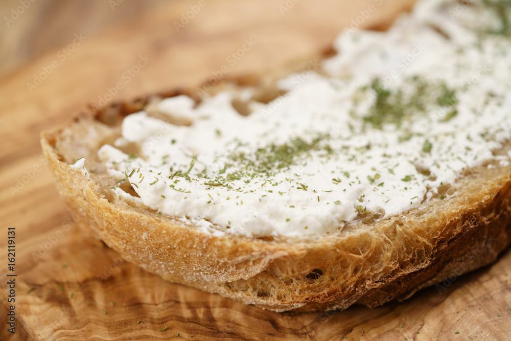 ricotta cheese with herbs on fresh rustic bread