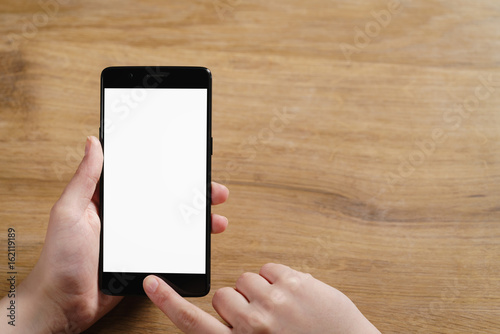 female teen hand using smartphone with blank white screen