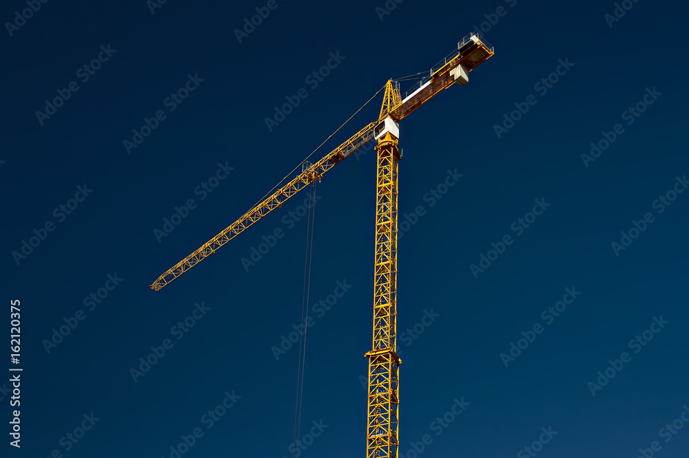 yellow crane on the background of the blue sky yellow crane on the background of the blue sky