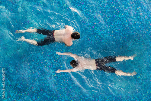 view from top pool with man swimming