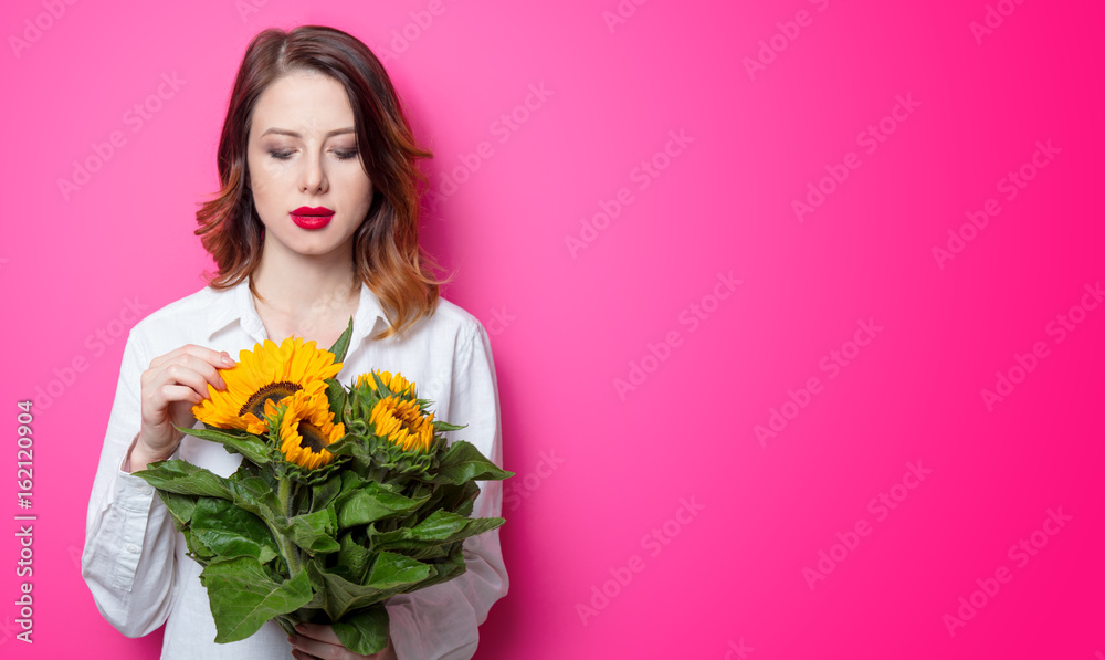 Portrait of young red-haired girl with sunflowers Portrait of young red-haired girl with sunflowers