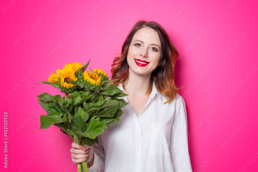 Portrait of young red-haired girl with sunflowers Portrait of young red-haired girl with sunflowers