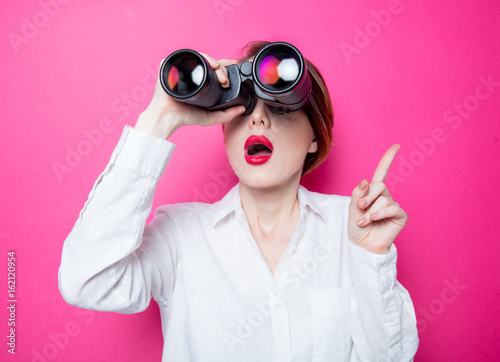 surprised businesswoman with binoculars photo